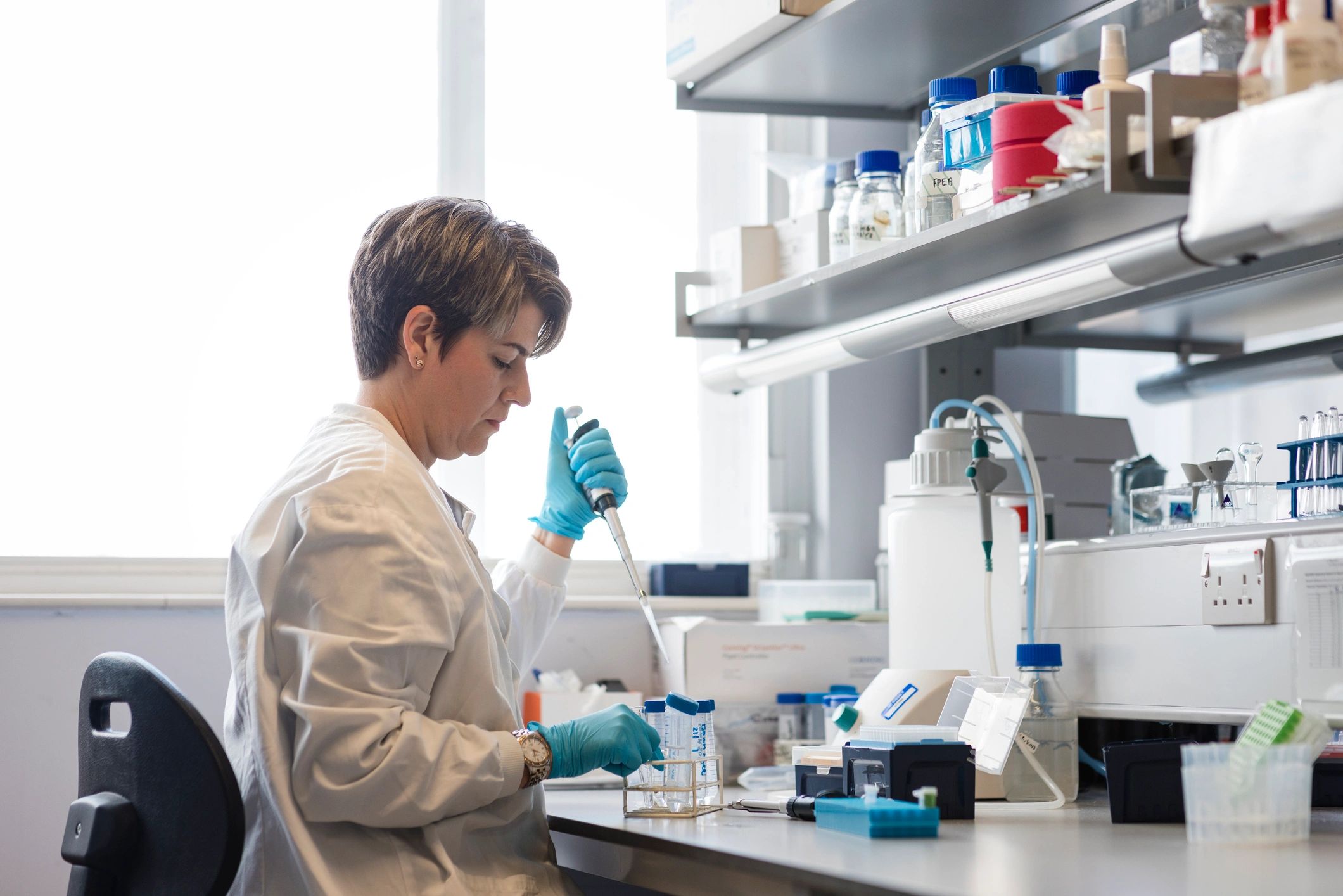 Lab professional handling testing equipment and samples