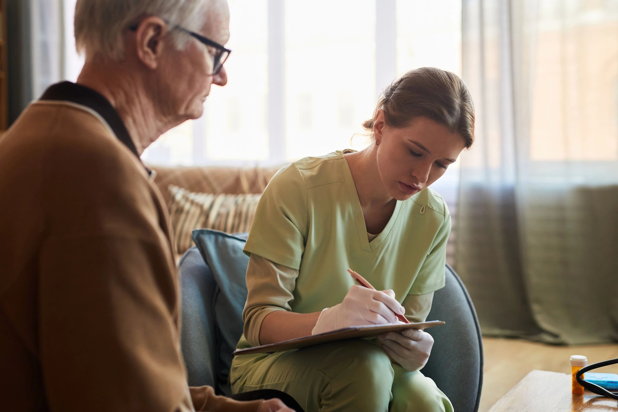 Healthcare professional consulting a patient at home